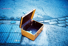 Empty yellow suitcase on a blue background.
