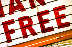 Backlit theatre billboard showing the word 'free'.