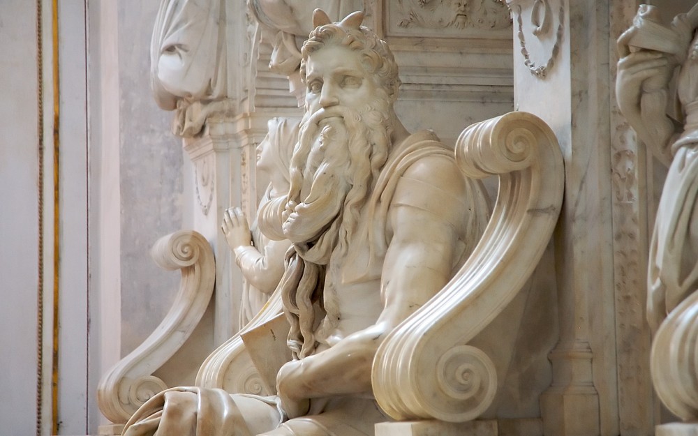 A white marble sculpture of a bearded devil