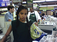 Checkout clerk looking unimpressed.
