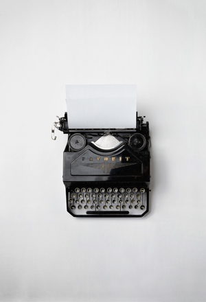 Typewriter with blank page.