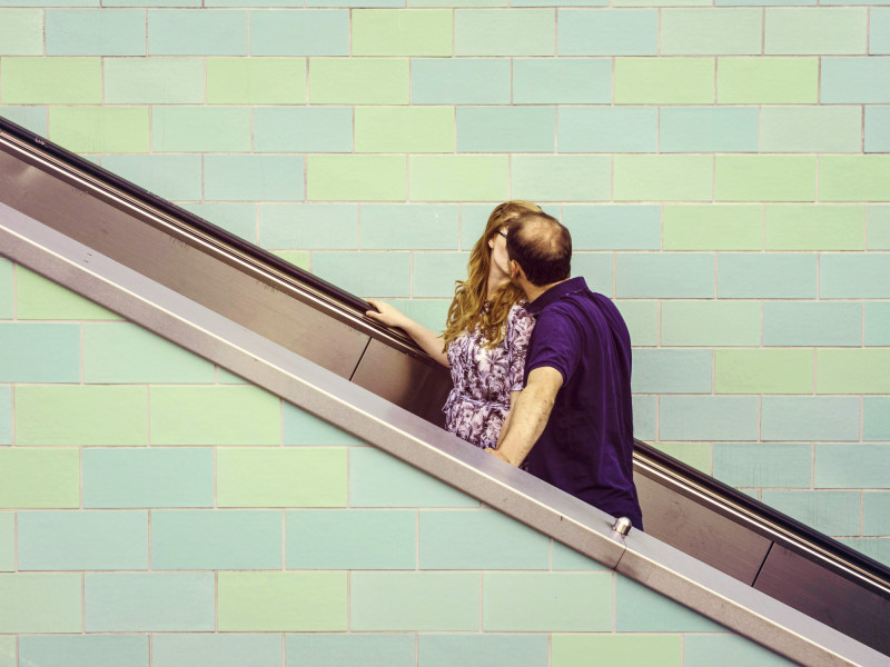 A couple kissing on an escalator - after
