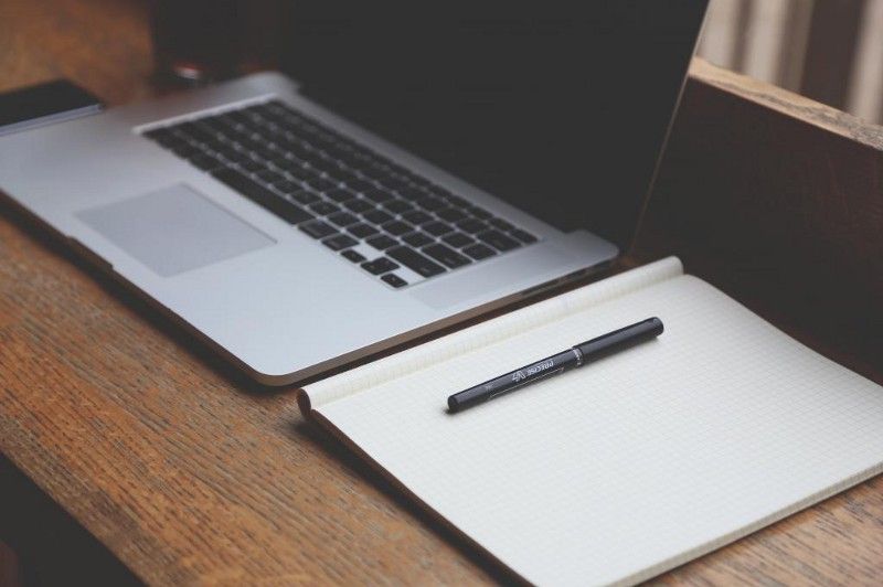 Designer desktop: Pad, pen and laptop