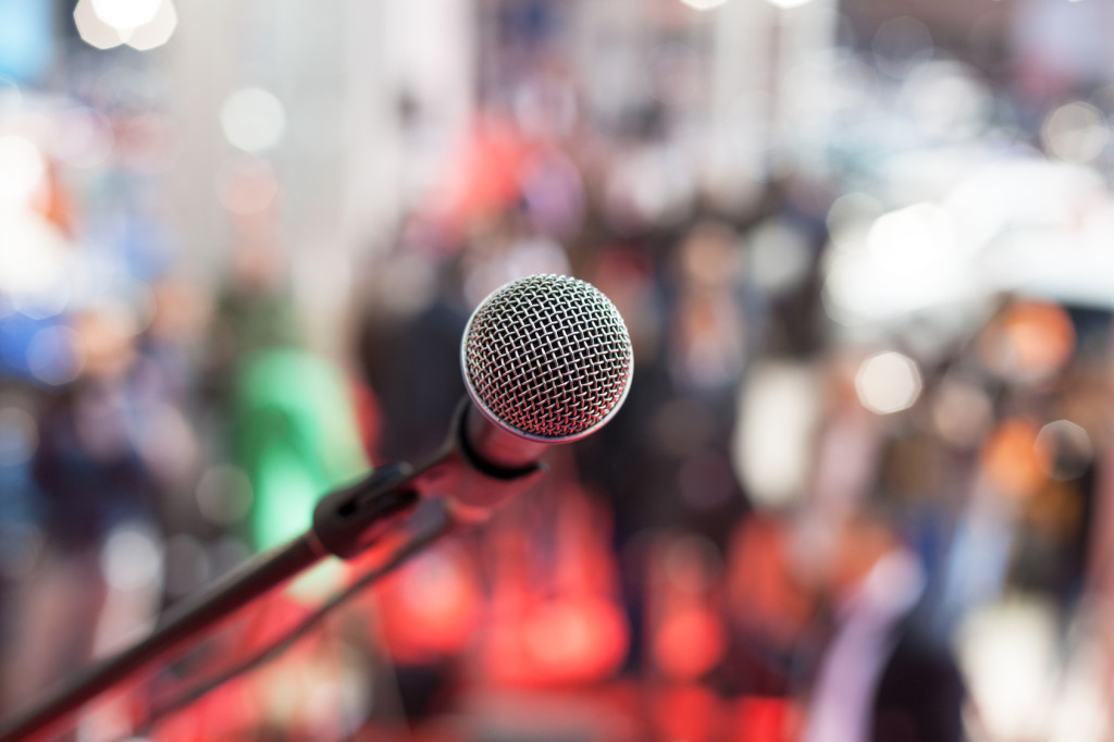 Microphone in front of blurred audience