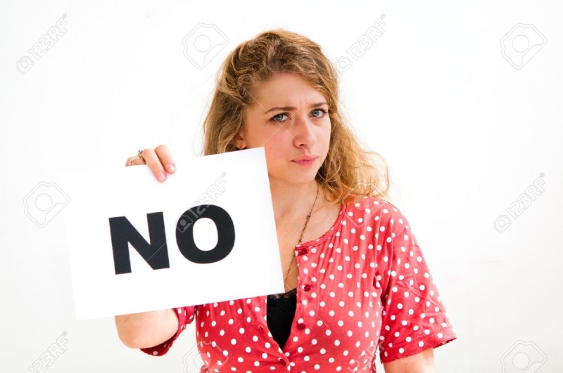 Woman holding 'No' sign