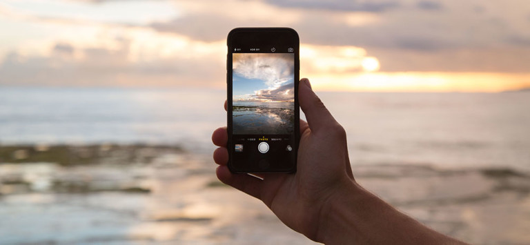 A person using an iPhone outside