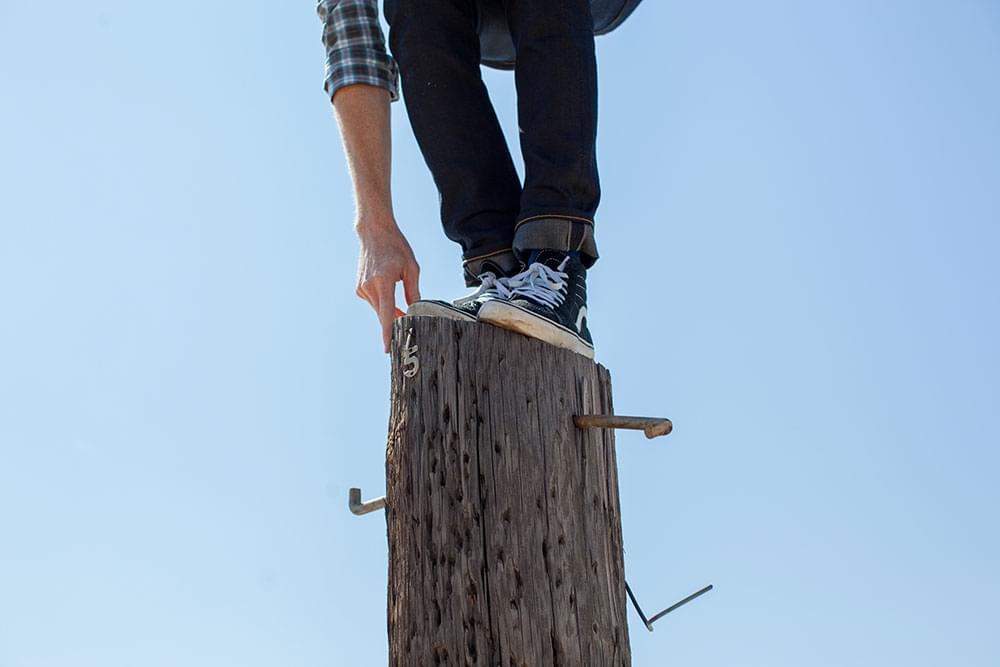 A person balancing on a pole