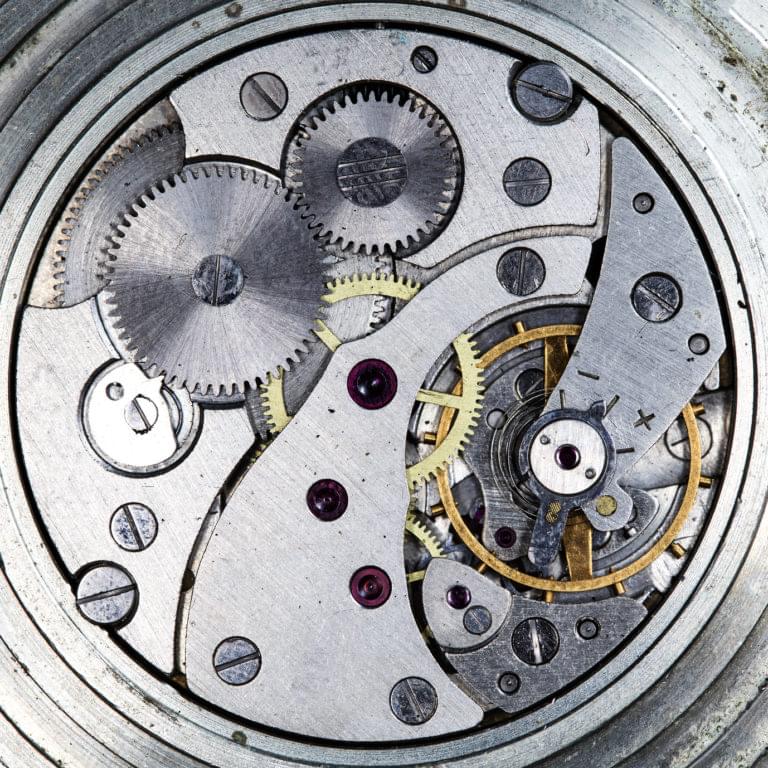A complex watch mechanism with many moving parts. A metaphor for how many see modern JS development.