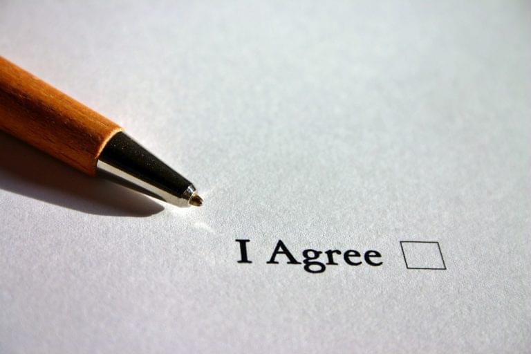 A pen on a piece of paper with a checkbox